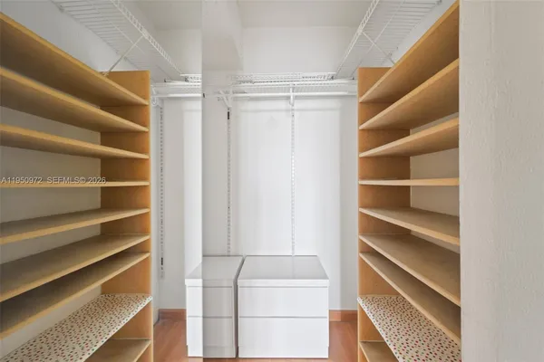 a view of walk in closet with empty racks