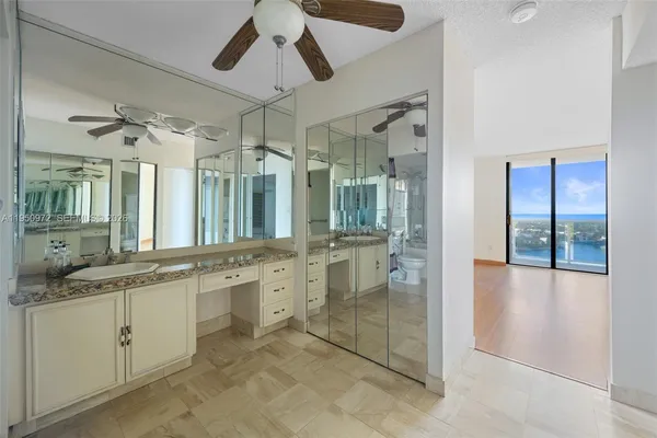 a large bathroom with a granite countertop sink mirror and shower