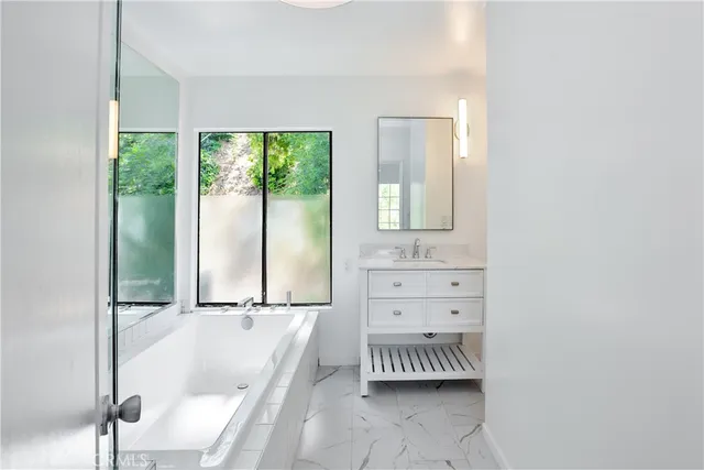 a bathroom with a bathtub and a shower