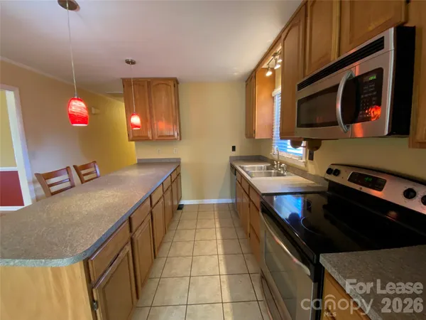 a kitchen with stainless steel appliances a stove a sink and a microwave