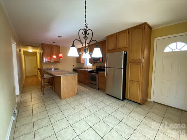 a kitchen with stainless steel appliances granite countertop a refrigerator a oven a sink and a refrigerator