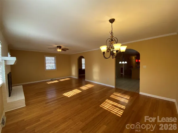 a view of a room with wooden floor and stairs