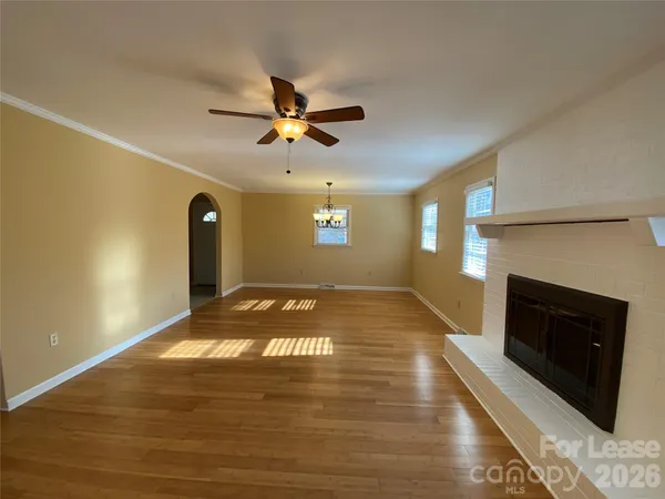 a view of a livingroom with a fireplace and window