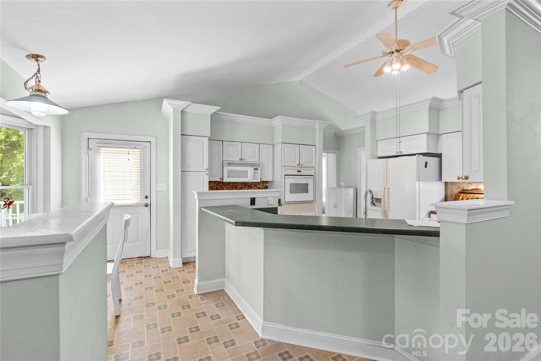 711 Spring Pointe Drive Stony Point, NC 28678 - Photo 15 of 47 a kitchen with stainless steel appliances a sink stove and refrigerator