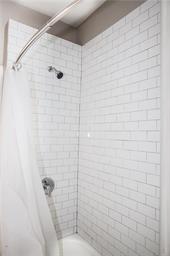 344 Bushkill Street, Unit 2 Easton, PA 18042 - Photo 13 of 30 A well-maintained shower with crisp white subway tile walls.