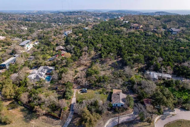 an aerial view of town with residential houses with outdoor space and trees