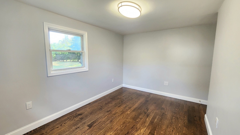 11 Christopher Road Brockton, MA 02302 - Photo 17 of 22 an empty room with wooden floor and windows