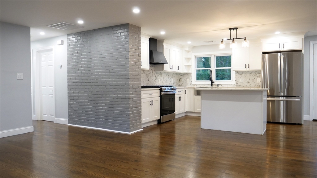 11 Christopher Road Brockton, MA 02302 - Photo 3 of 22 a kitchen with stainless steel appliances granite countertop a refrigerator a stove and a wooden floors