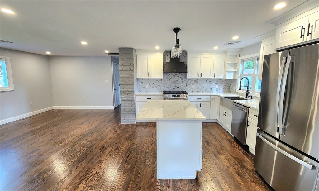 11 Christopher Road Brockton, MA 02302 - Photo 7 of 22 a kitchen with kitchen island stainless steel appliances a sink a stove a refrigerator cabinets and wooden floor