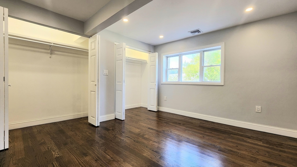 11 Christopher Road Brockton, MA 02302 - Photo 9 of 22 an empty room with wooden floor and a window