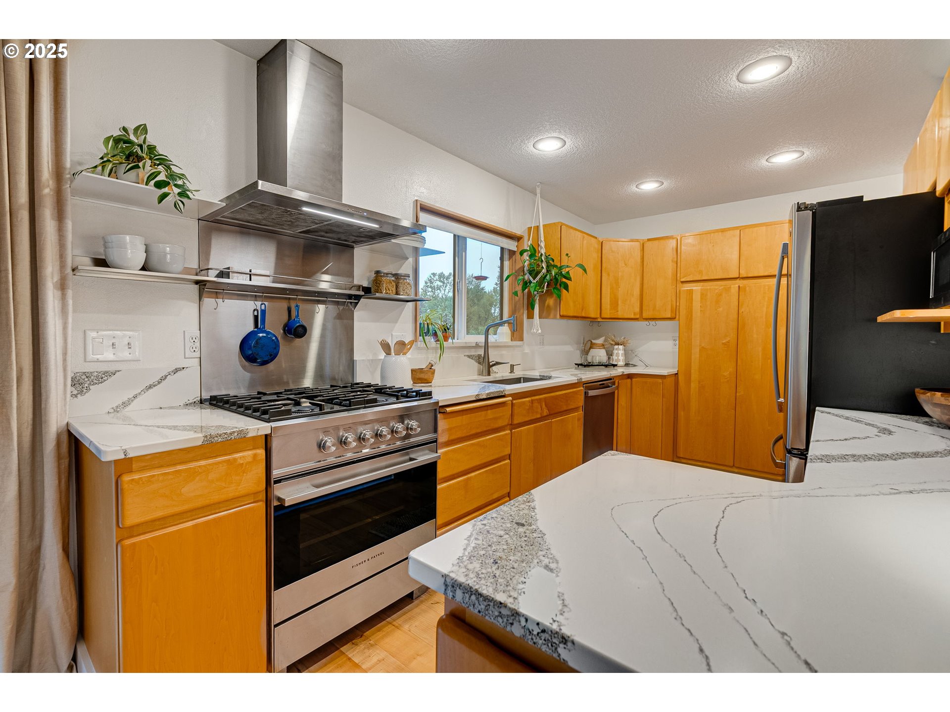 2733 Northeast 92nd Avenue Portland, OR 97220 - Photo 17 of 48 a kitchen with stainless steel appliances granite countertop a sink a stove and a refrigerator