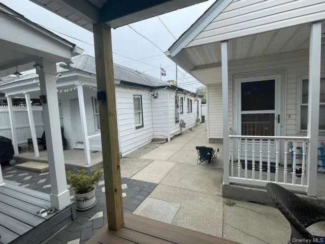 a view of a porch with a chair and potted plants