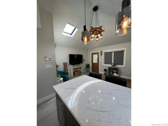 a view of a dining room with furniture and a flat screen tv