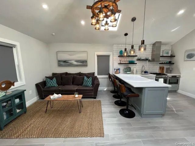 a living room with furniture and a chandelier