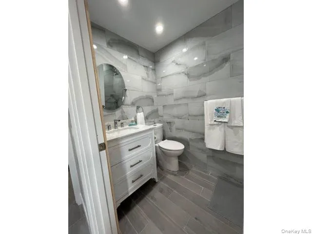 a bathroom with a double vanity sink toilet and a mirror