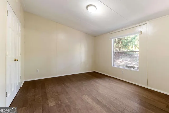 a bedroom with a large bed and a window