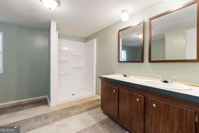 a bathroom with a sink vanity and mirror