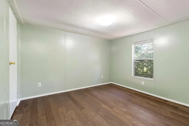 a bedroom with a large bed and potted plant