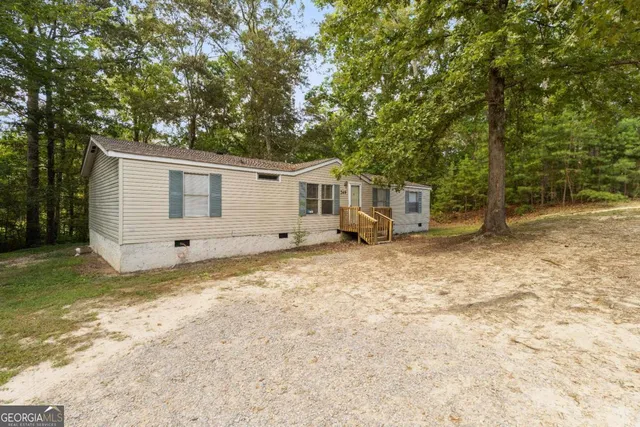 a view of a house with a yard and deck