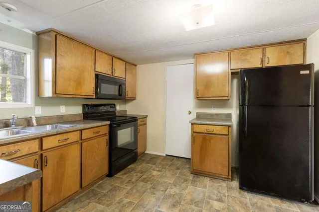 a kitchen with stainless steel appliances granite countertop a sink and a stove top oven