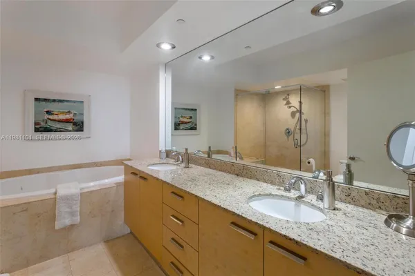 a bathroom with a granite countertop sink mirror and double