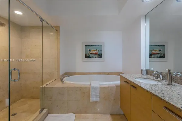 a bathroom with a tub sink and shower