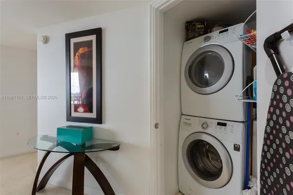 a view of a hallway with washer and dryer