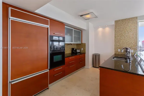 a kitchen with stainless steel appliances granite countertop a refrigerator and a sink