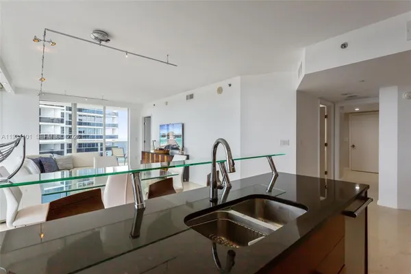 a kitchen with a sink and a counter top space