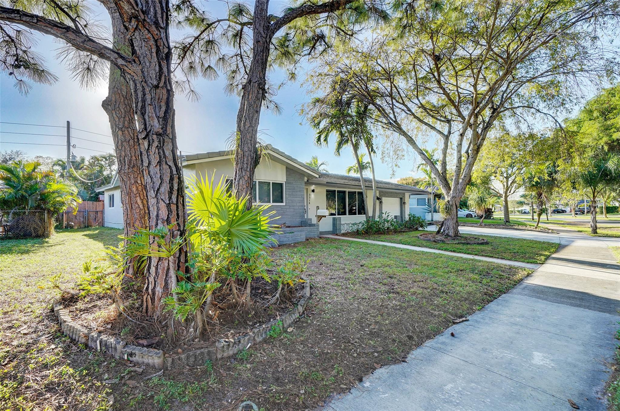 3314 West Park Road Hollywood, FL 33021 - Photo 3 of 25 a front view of a house with a yard and trees