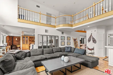 a living room with patio furniture and a chandelier