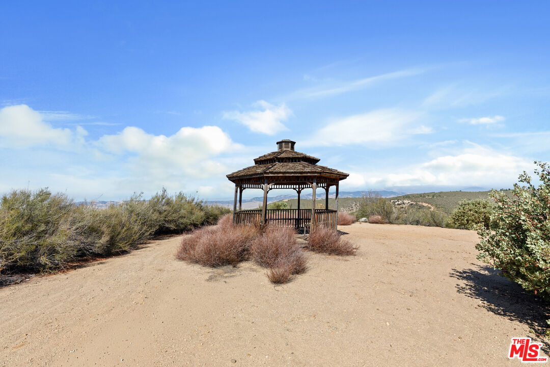 28765 Pine Canyon Road Lake Hughes, CA 93532 - Photo 30 of 58 a backyard of a house with table and chairs