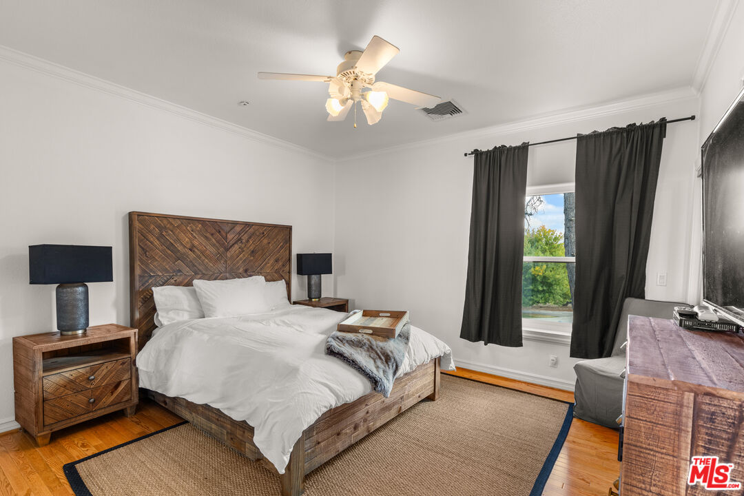 28765 Pine Canyon Road Lake Hughes, CA 93532 - Photo 51 of 58 a bedroom with a bed and a chandelier