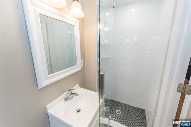 a bathroom with a sink a mirror and a toilet