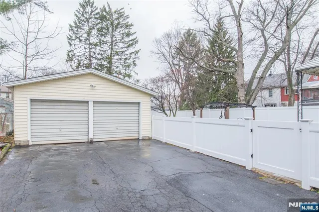 a view of a house with a yard and garage