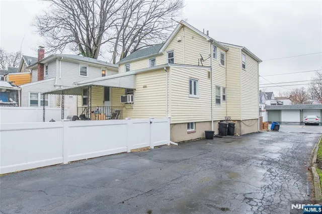 a view of a white house with a large space and a large window