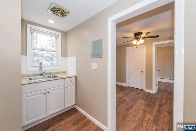 a bathroom with a sink a mirror and a shower