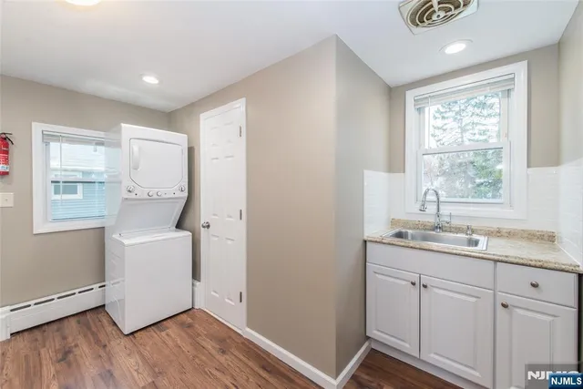 a room with a sink and wooden floor