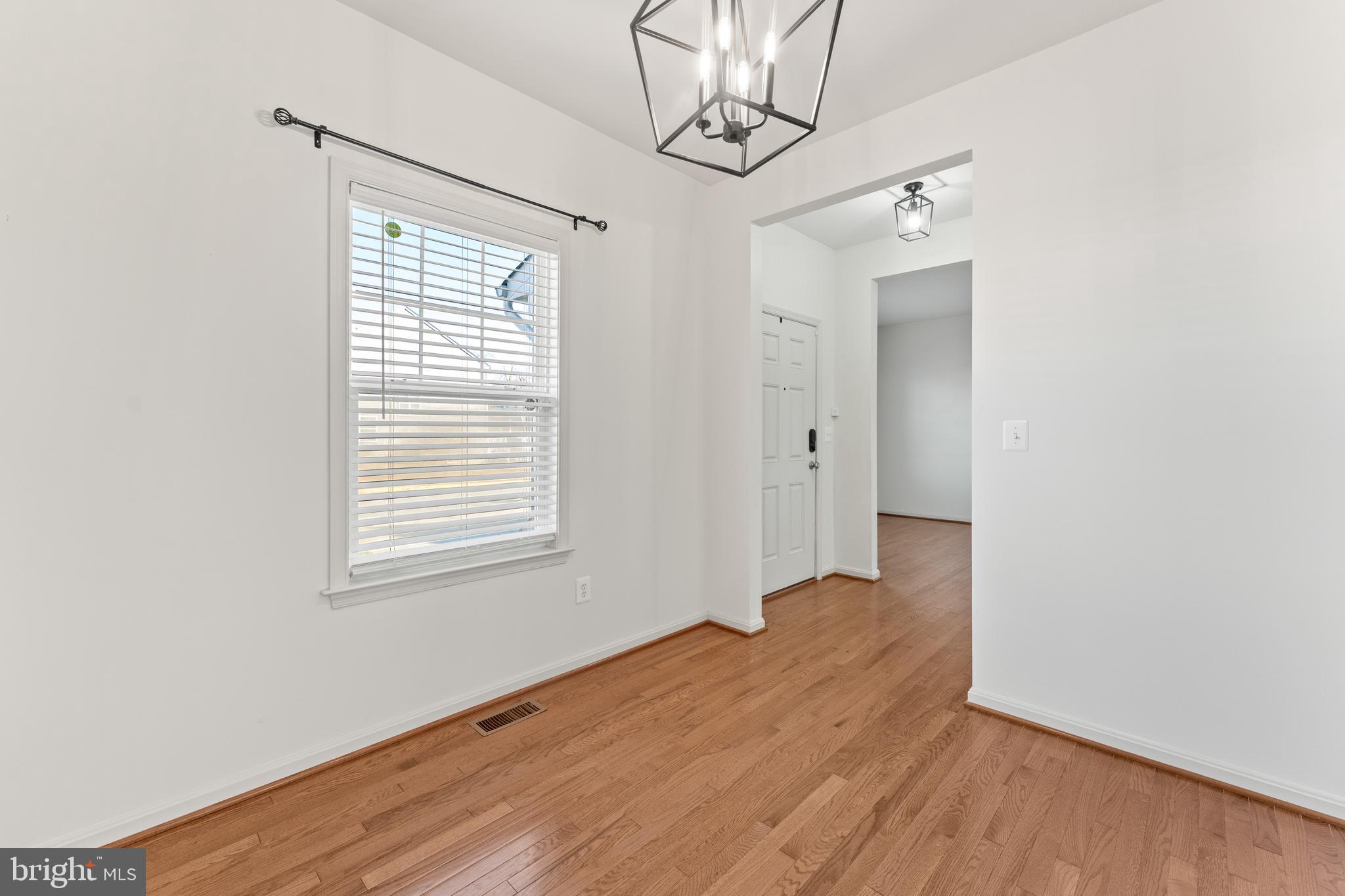 18350 Congressional Circle Ruther Glen, VA 22546 - Photo 15 of 55 a view of an empty room with wooden floor and a window