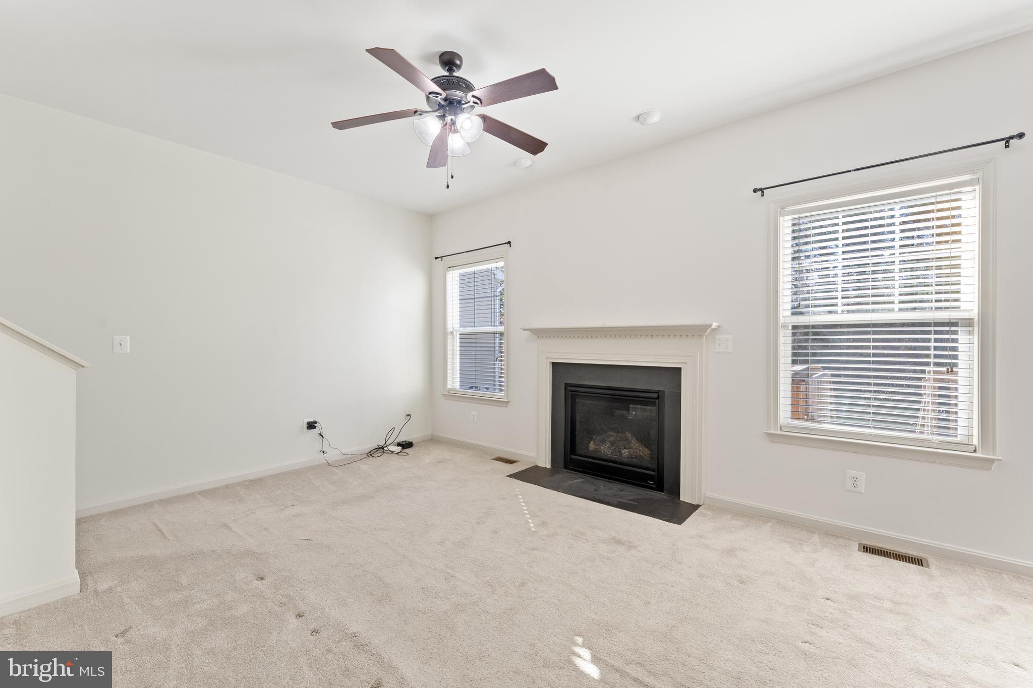 18350 Congressional Circle Ruther Glen, VA 22546 - Photo 16 of 55 an empty room with windows and fireplace