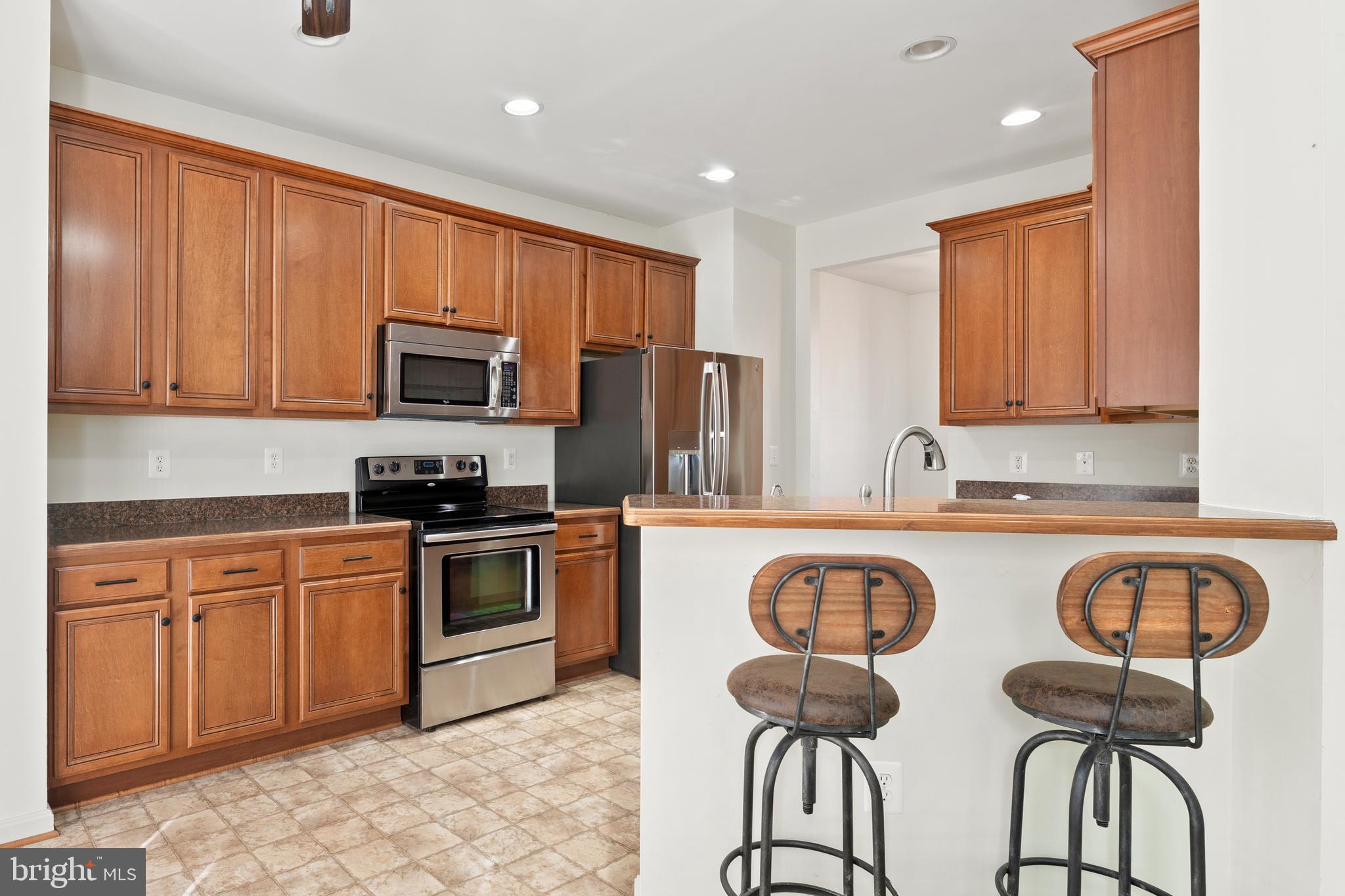 18350 Congressional Circle Ruther Glen, VA 22546 - Photo 22 of 55 a kitchen with stainless steel appliances granite countertop a table chairs sink and cabinets