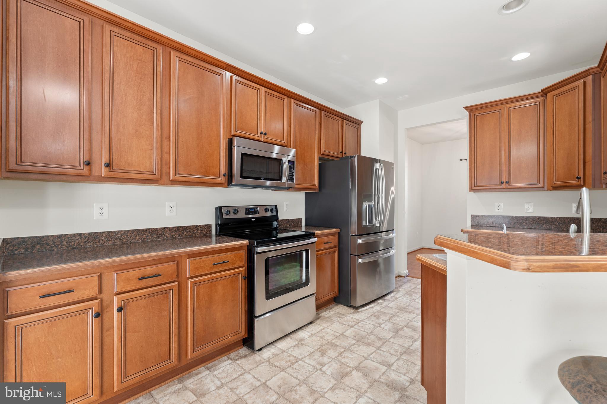18350 Congressional Circle Ruther Glen, VA 22546 - Photo 24 of 55 a kitchen with stainless steel appliances granite countertop a refrigerator stove microwave sink and cabinets