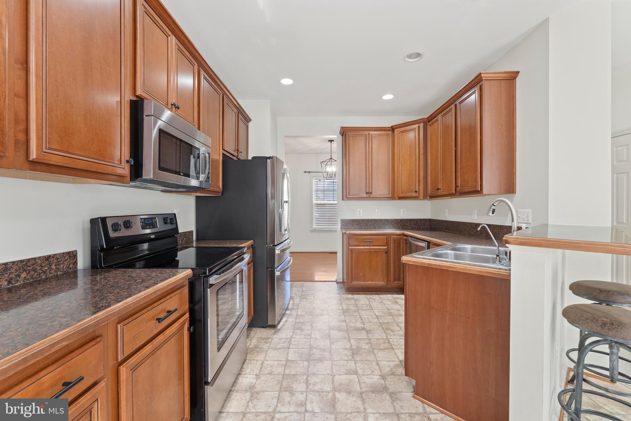 18350 Congressional Circle Ruther Glen, VA 22546 - Photo 25 of 55 a kitchen with stainless steel appliances granite countertop a refrigerator stove top oven a sink and dishwasher