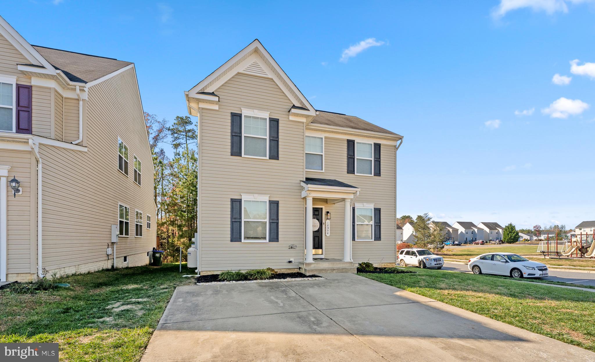 18350 Congressional Circle Ruther Glen, VA 22546 - Photo 3 of 55 a front view of a house with a garden