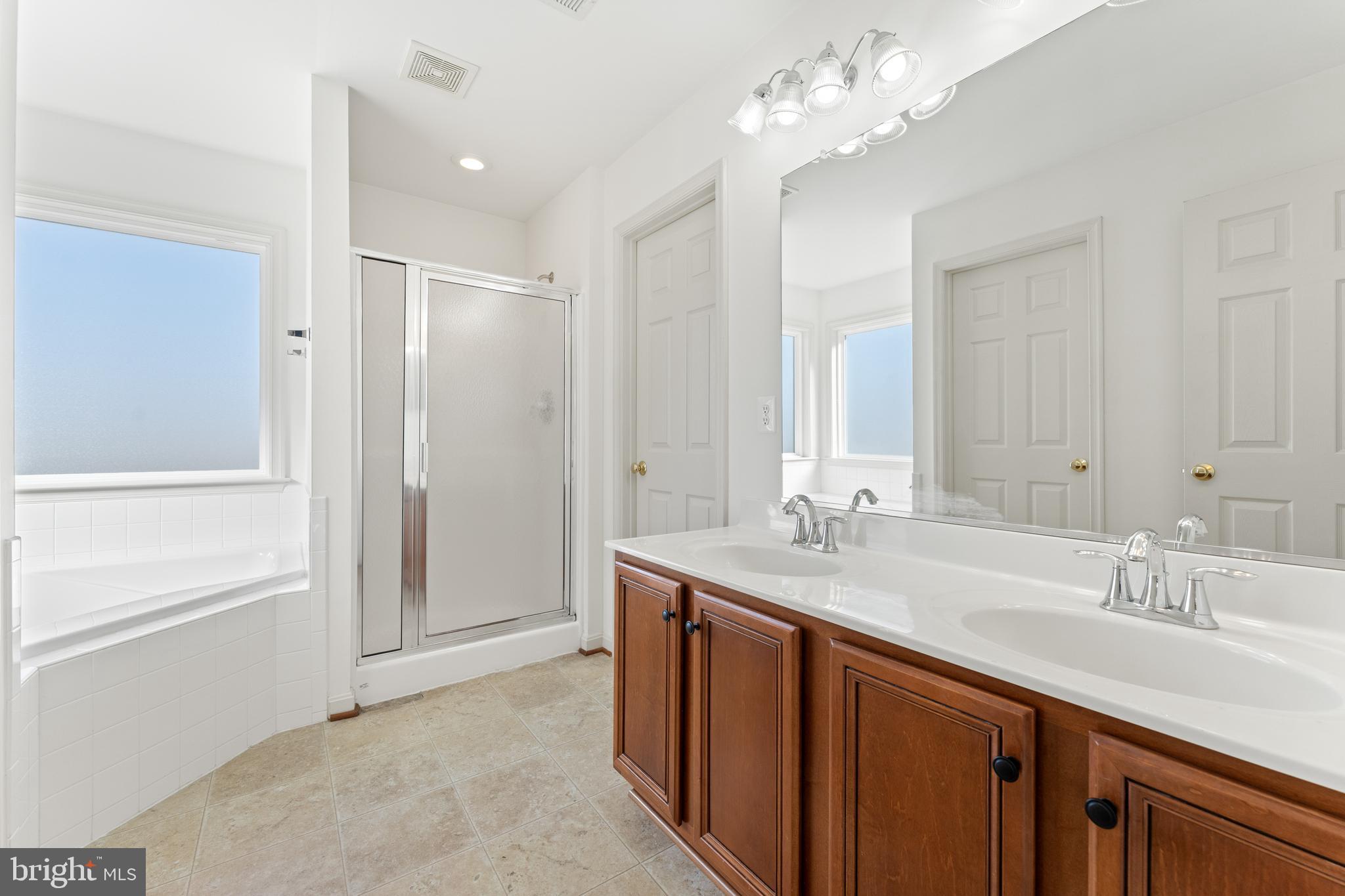 18350 Congressional Circle Ruther Glen, VA 22546 - Photo 37 of 55 a bathroom with a double vanity sink and a mirror
