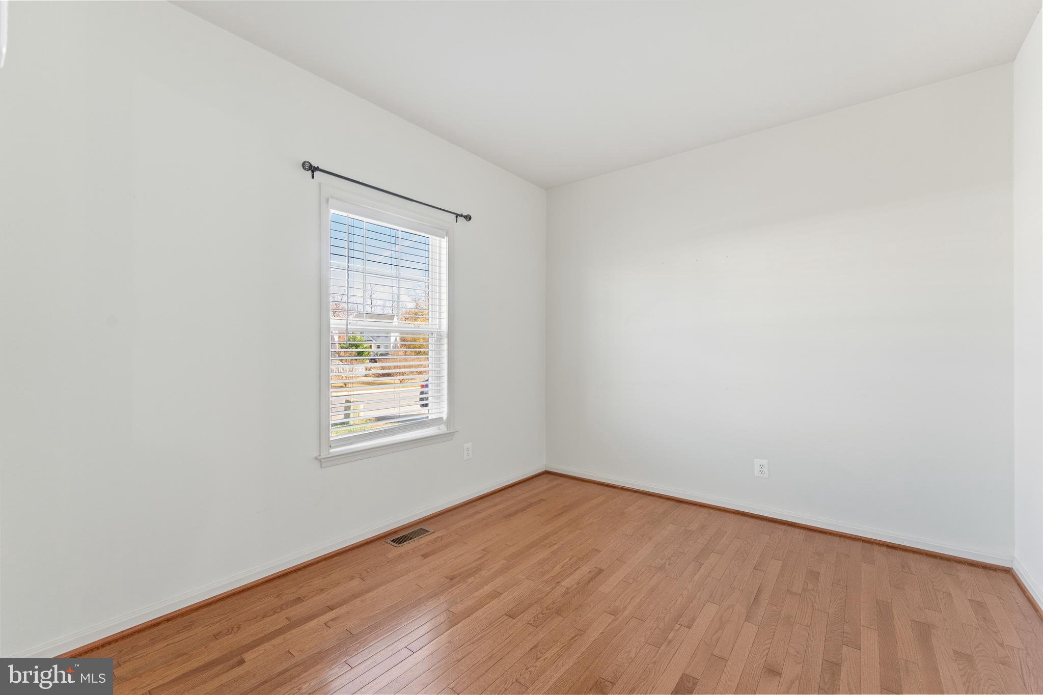 18350 Congressional Circle Ruther Glen, VA 22546 - Photo 10 of 55 an empty room with wooden floor and windows