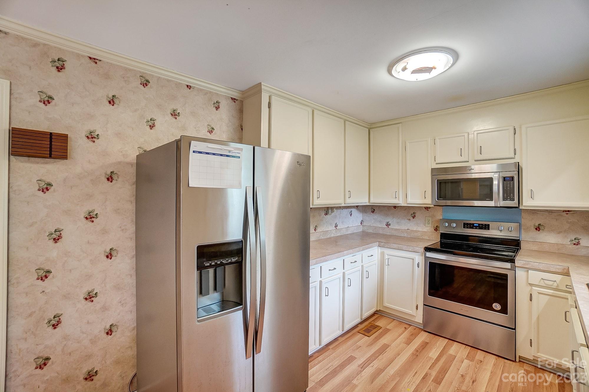 744 Ike Lynch Road Dallas, NC 28034 - Photo 11 of 47 a kitchen with stainless steel appliances a refrigerator stove and sink