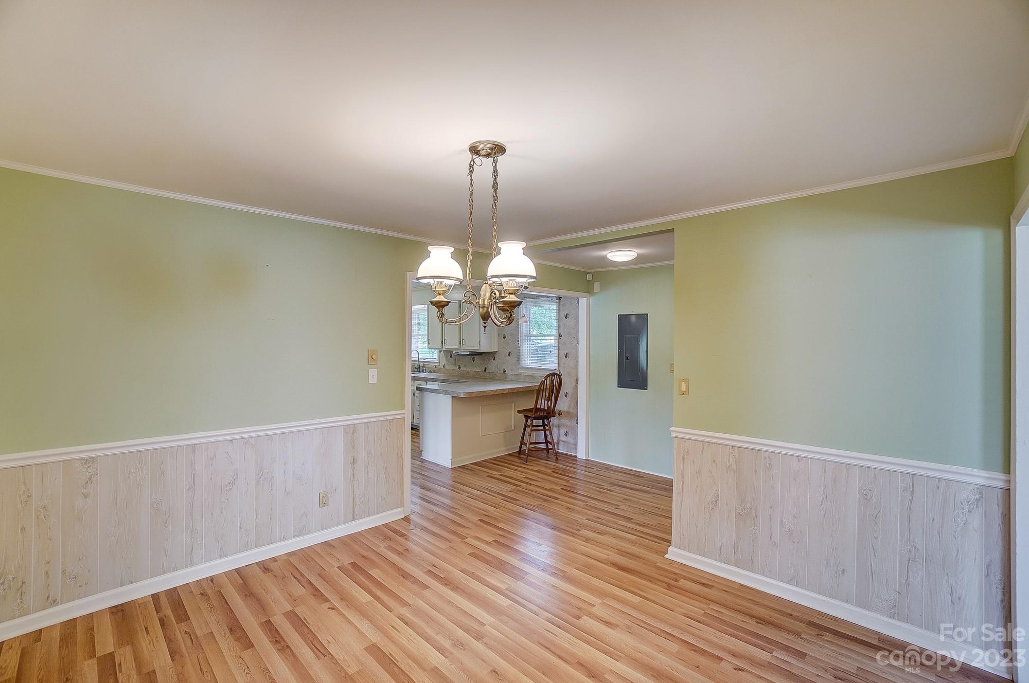744 Ike Lynch Road Dallas, NC 28034 - Photo 16 of 47 a view of a room with wooden floor a kitchen space and a window
