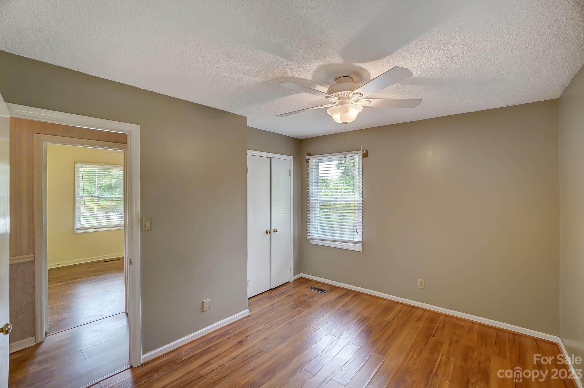 744 Ike Lynch Road Dallas, NC 28034 - Photo 25 of 47 an empty room with wooden floor and windows