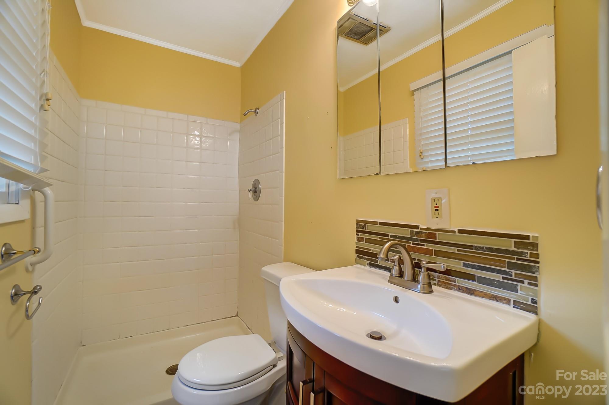 744 Ike Lynch Road Dallas, NC 28034 - Photo 26 of 47 a bathroom with a sink a toilet and shower